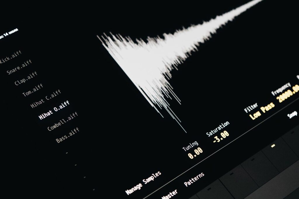 Close-up of a digital audio editing interface displaying sound waves and file names.