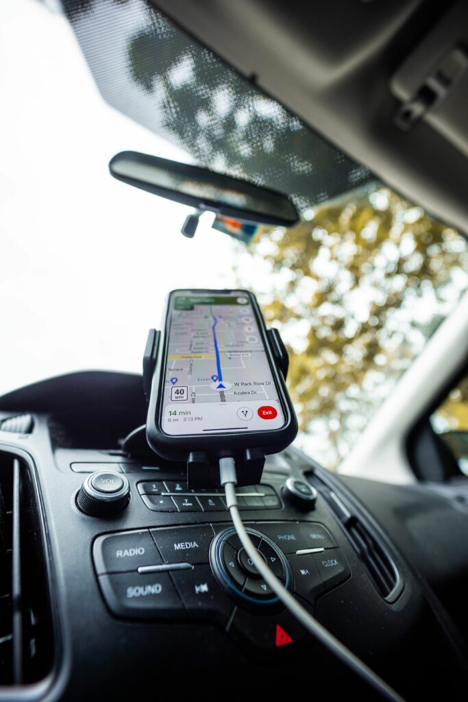 Smartphone mounted on car dashboard running a navigation app. Ideal for travel and technology themes.